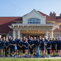 GVSU Alumni pose in front of Alumni House & Visitor Center